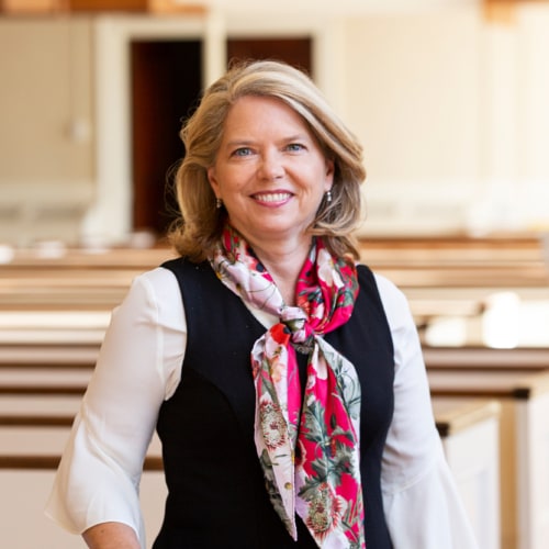 Rev. Dr. Sarah Butter in the pews of Village Church