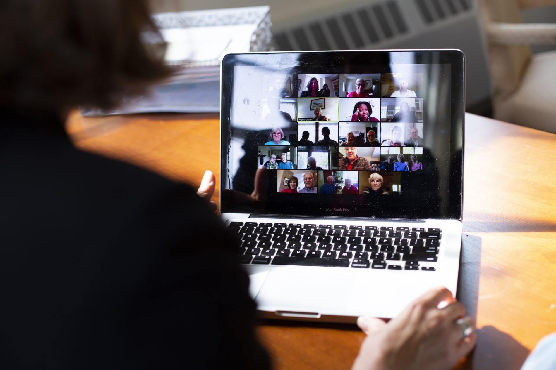 A group of people gather on Zoom for a virtual adult education session