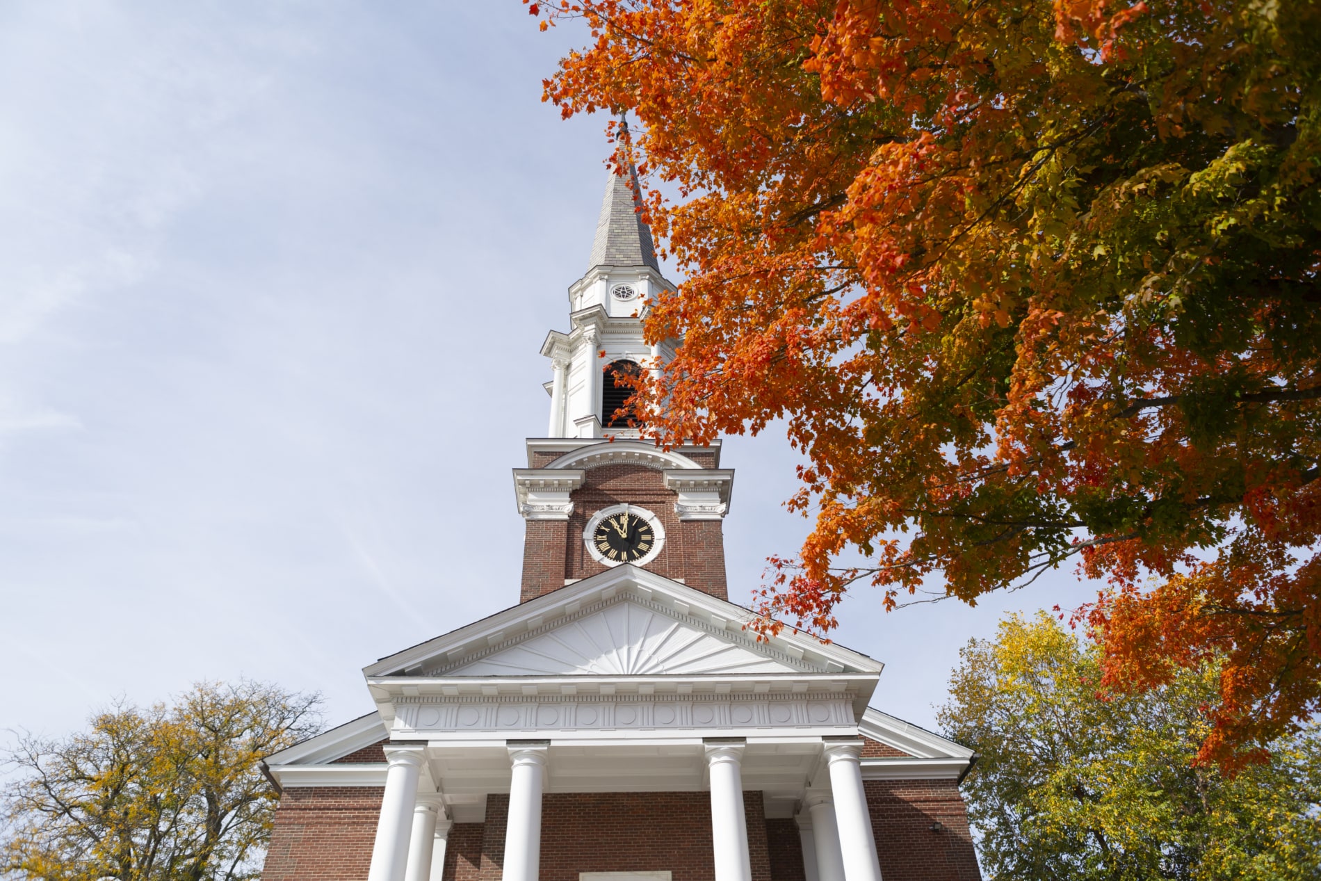 The facade of the Village Church with its clocktower steeple