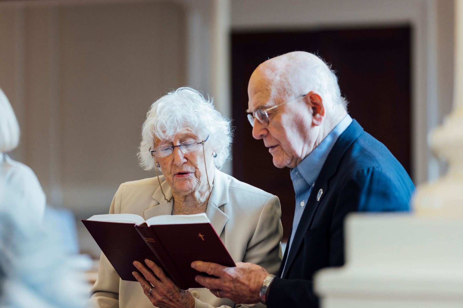 Couple sings from hymnbook in church